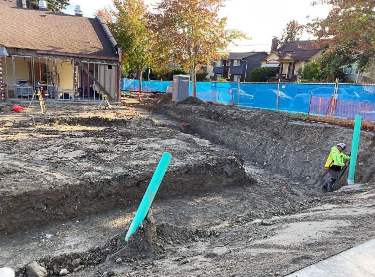 a large trench outside of a building with one wall open